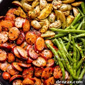 close up of potatoes, green beans, and sausage slices in a black skillet