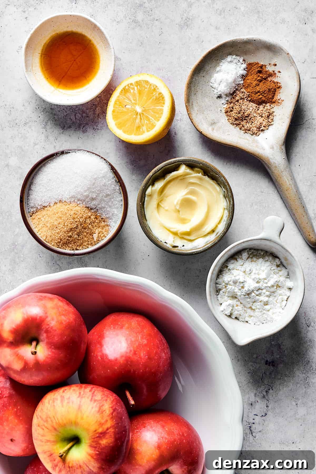 Apple filling ingredients measured into small dishes and arranged on a work surface.