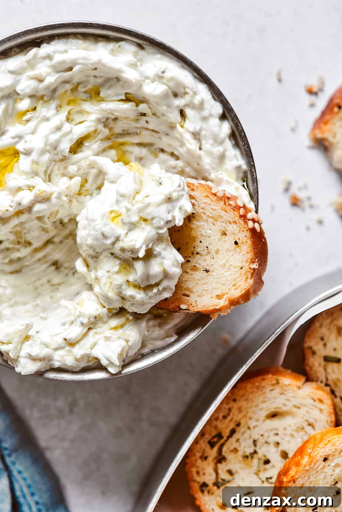 Scooping creamy dip out of a small bowl.