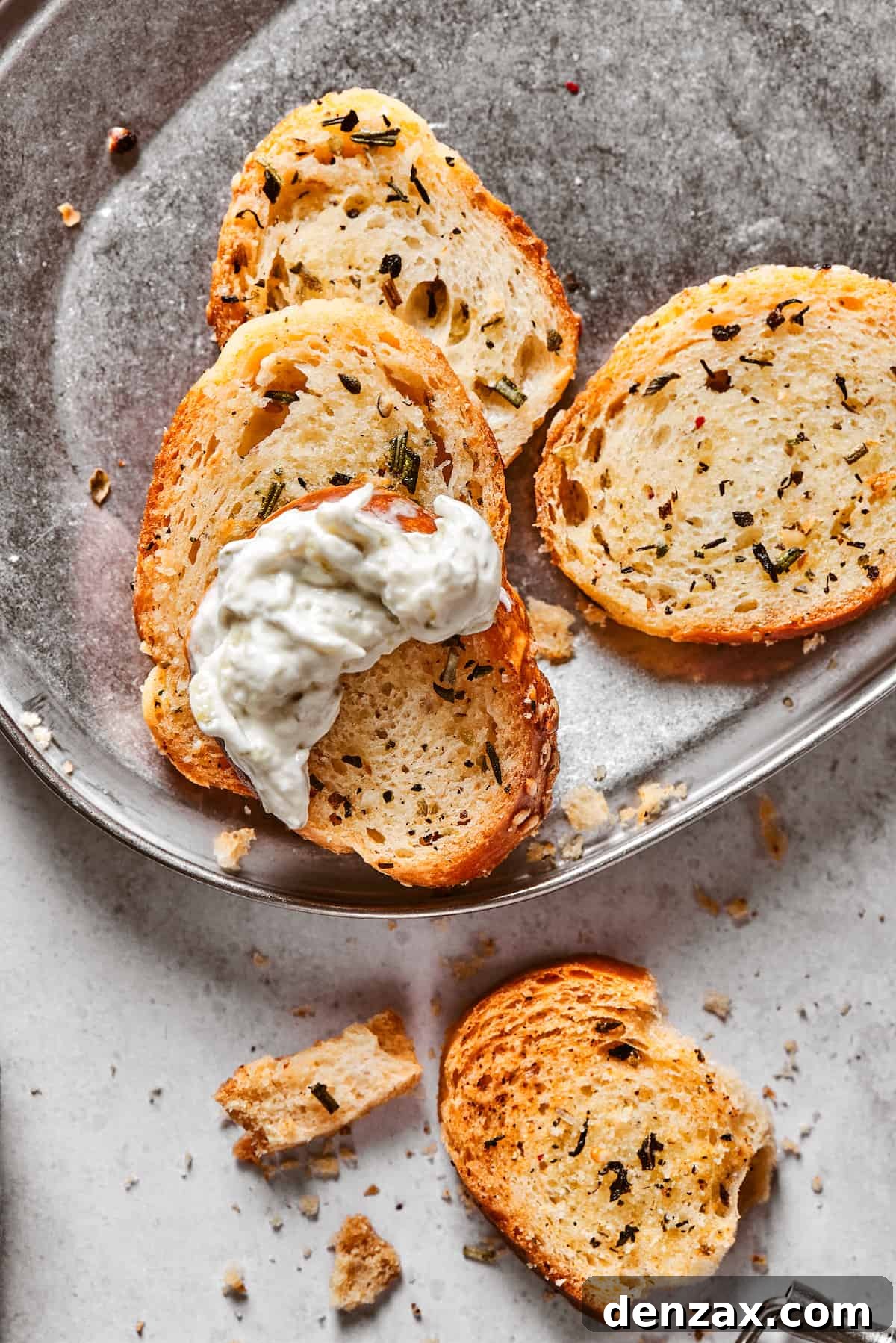 A few baked chips, one dipped in creamy dip.