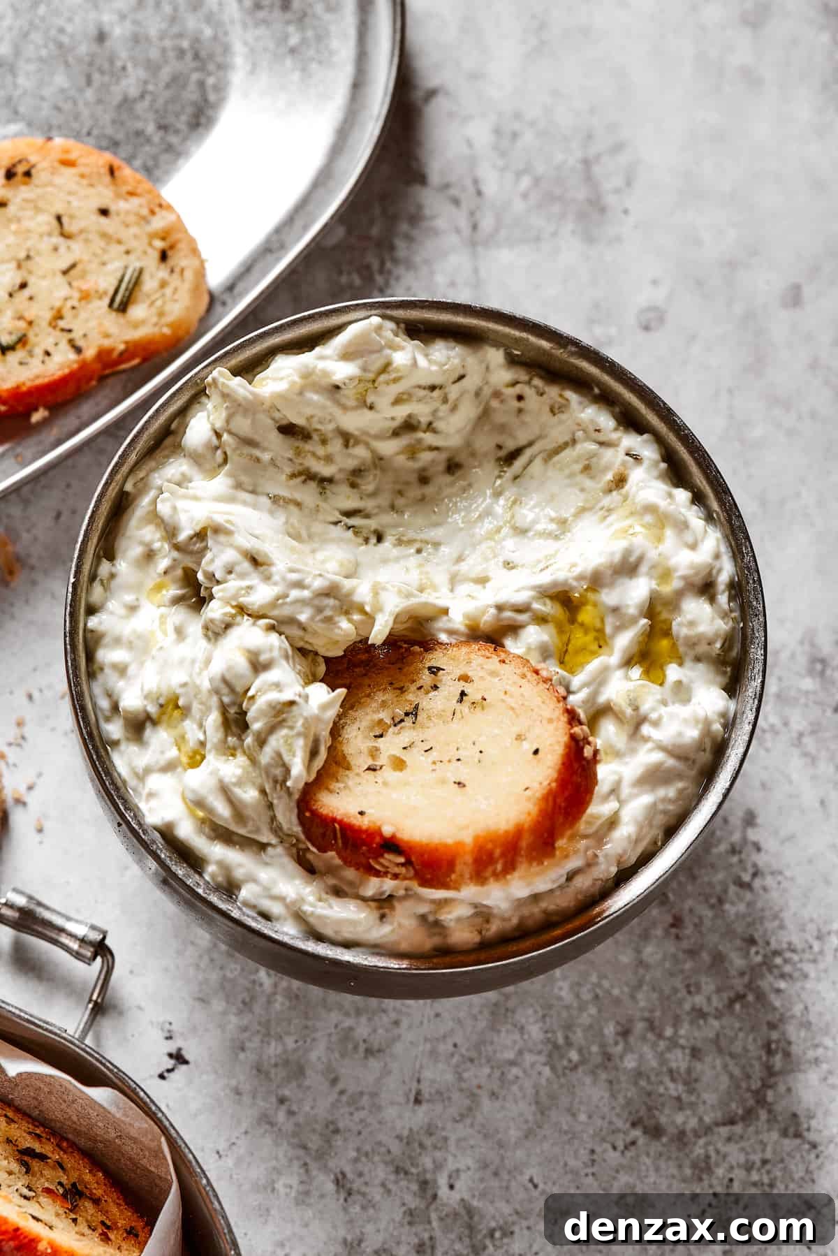 Dipping a chip into a dish of creamy dip.