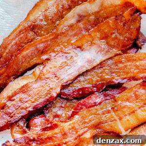 Oven baked bacon on a paper towel.
