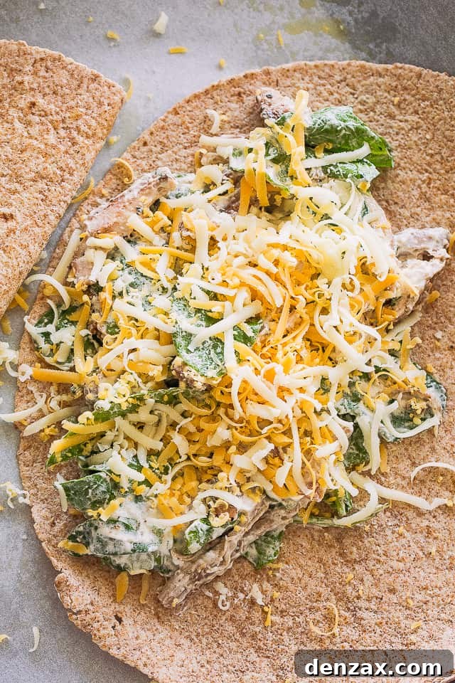 Adding the chicken and cheese mixture over a tortilla.