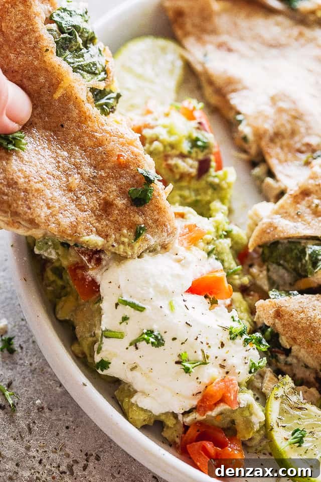 Dipping a baked quesadilla in sour cream and guac.