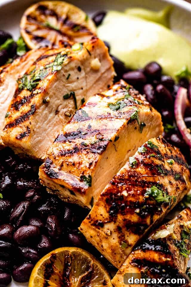 Sliced grilled chicken breast set over black beans