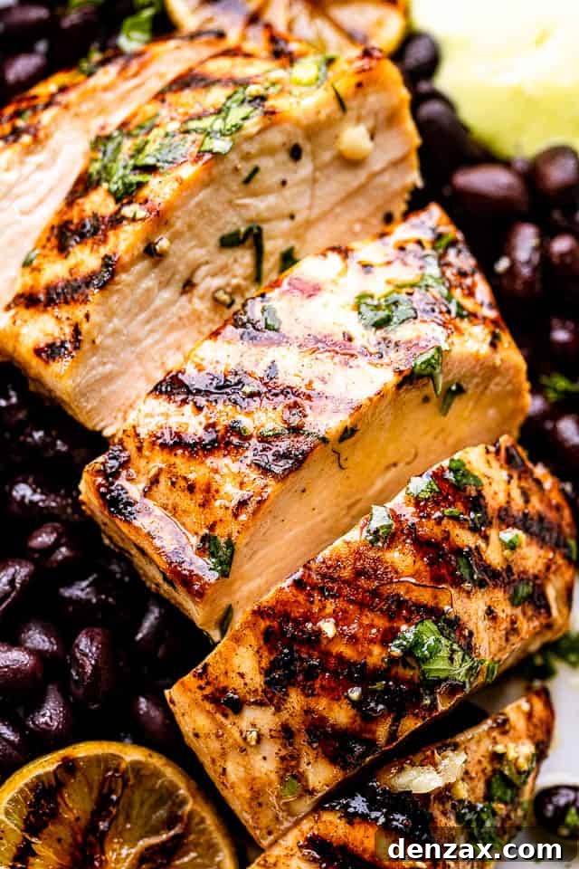close up view of mojo chicken with black beans under it