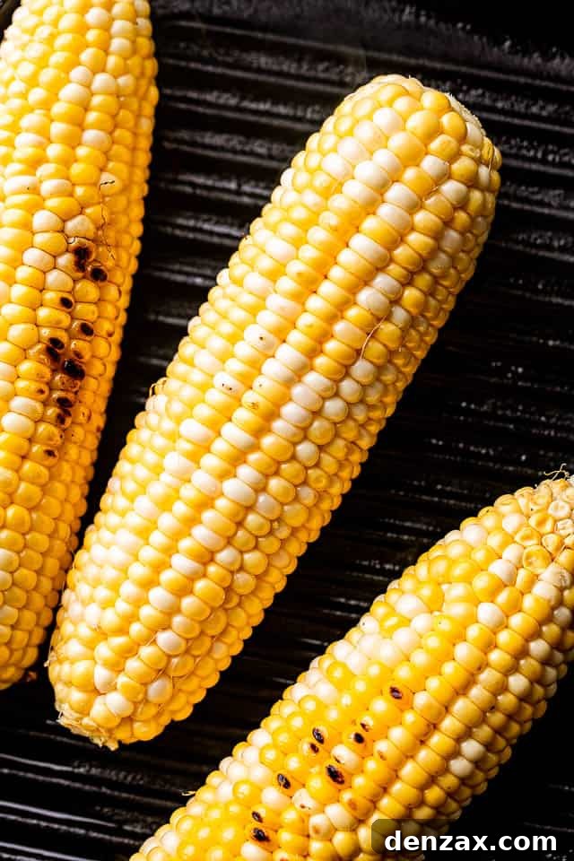 3 ear cobs of corn on the grill