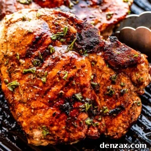 using tongs to turn over grilled pork chops