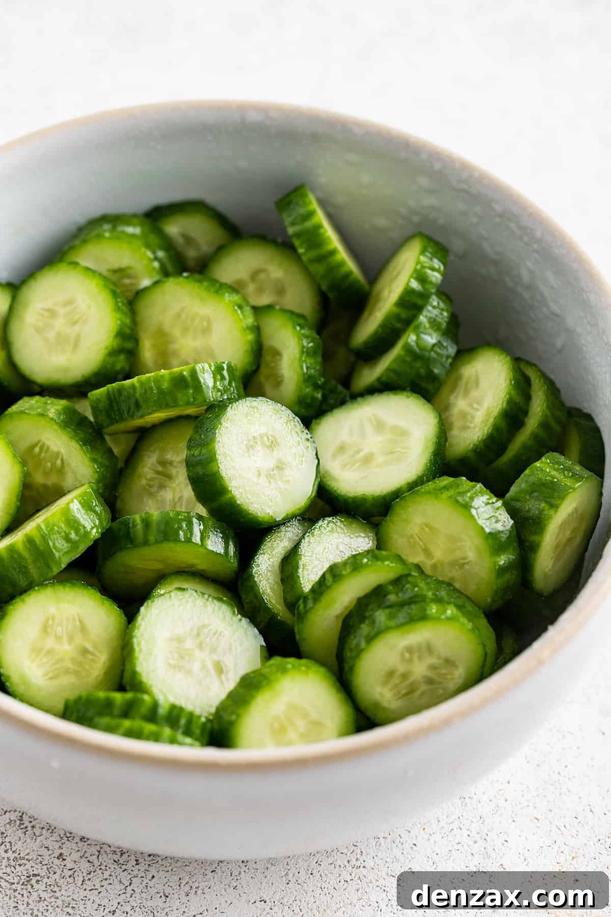 Drizzled with homemade dressing, this Jennifer Aniston quinoa salad with crunchy chickpeas is super light and refreshing. Salting the cucumbers.