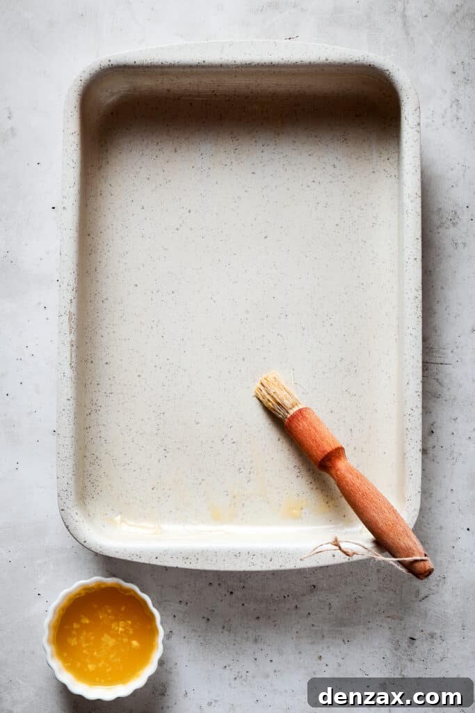 Brushing a baking dish with butter.