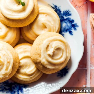 A blue and white flowered plate of iced orange cookies.