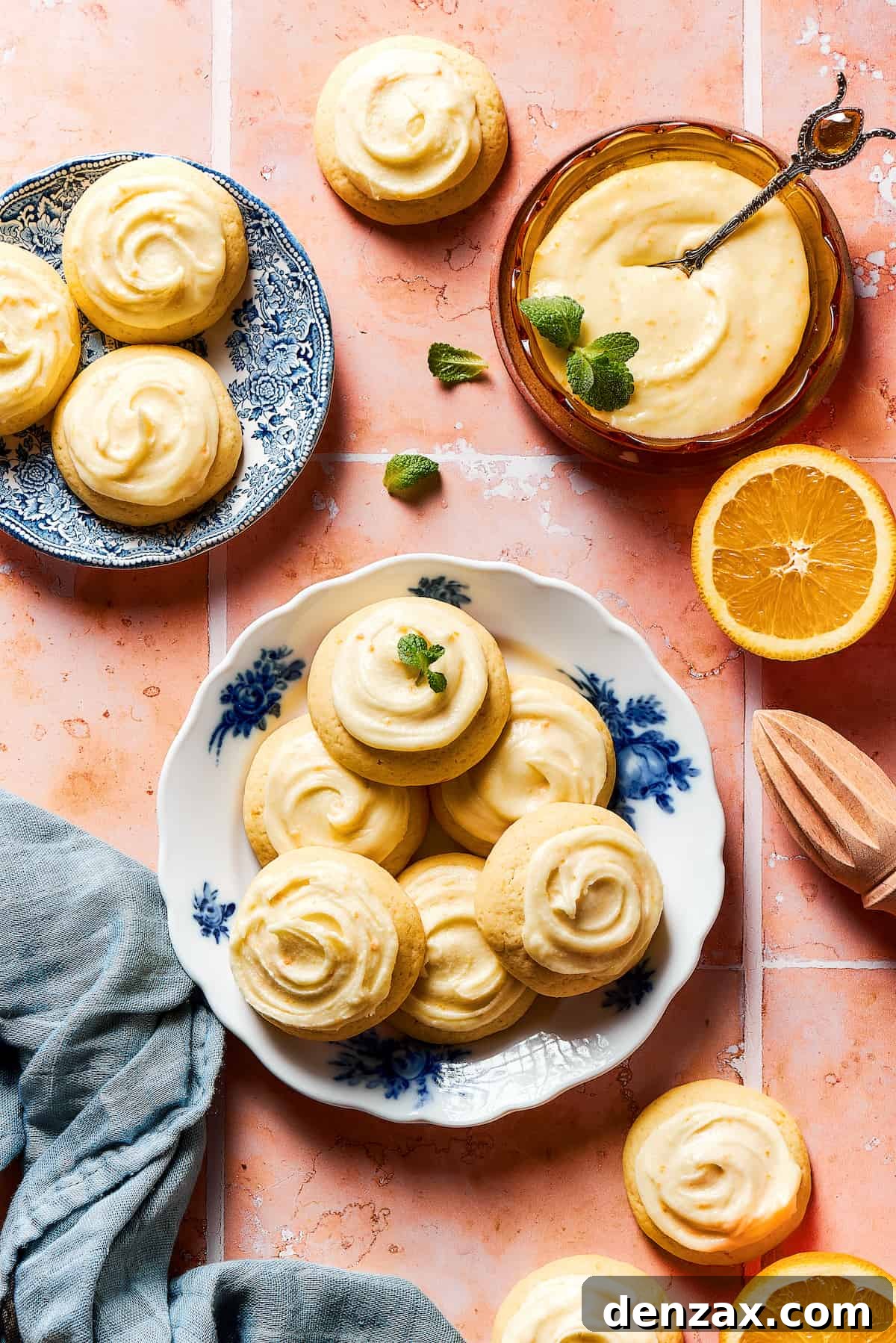 A platter of iced cookies with more cookies on a small saucer.