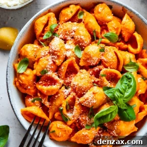Pasta in a bowl, garnished with basil.