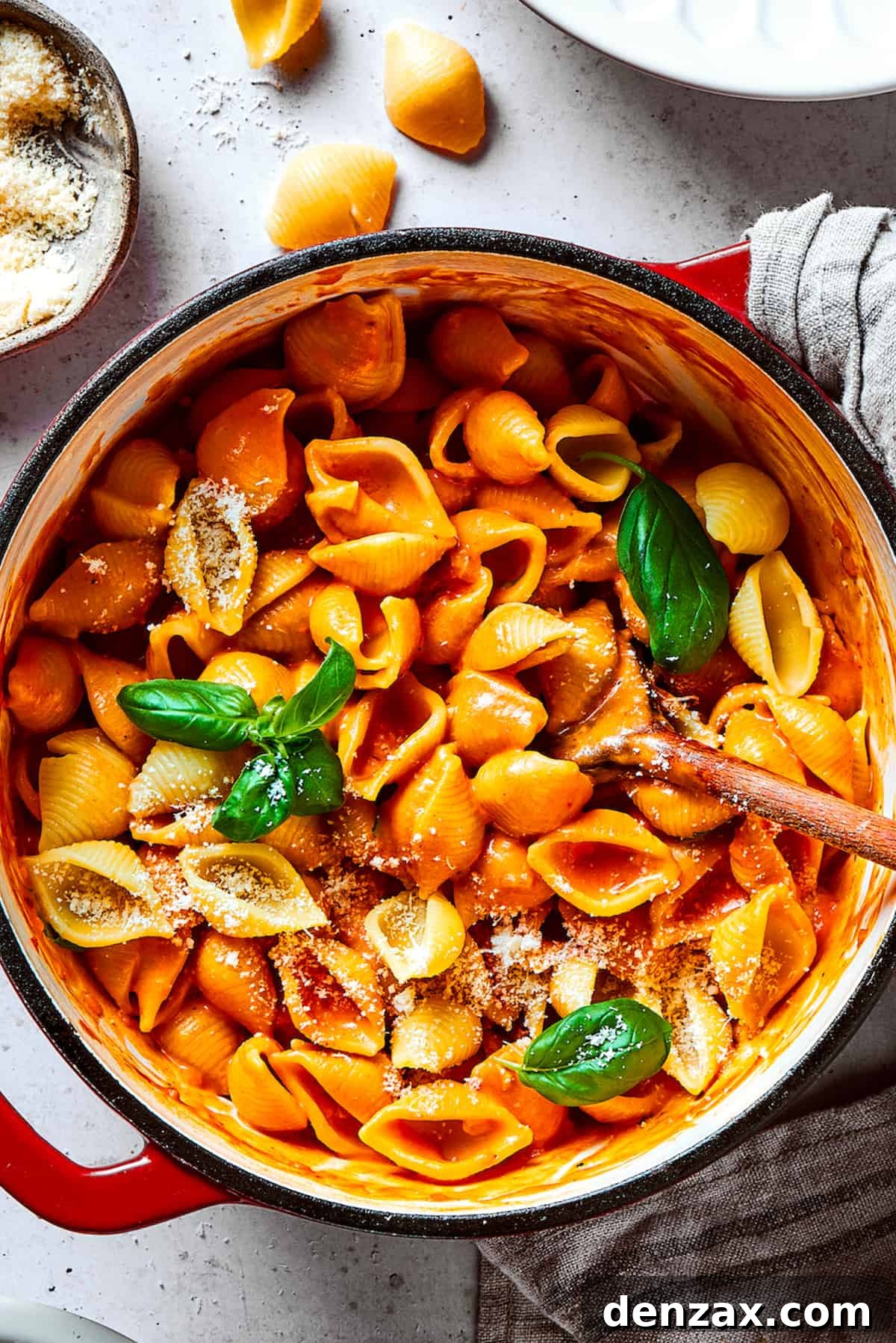 A pot of pasta shells in creamy tomato sauce.