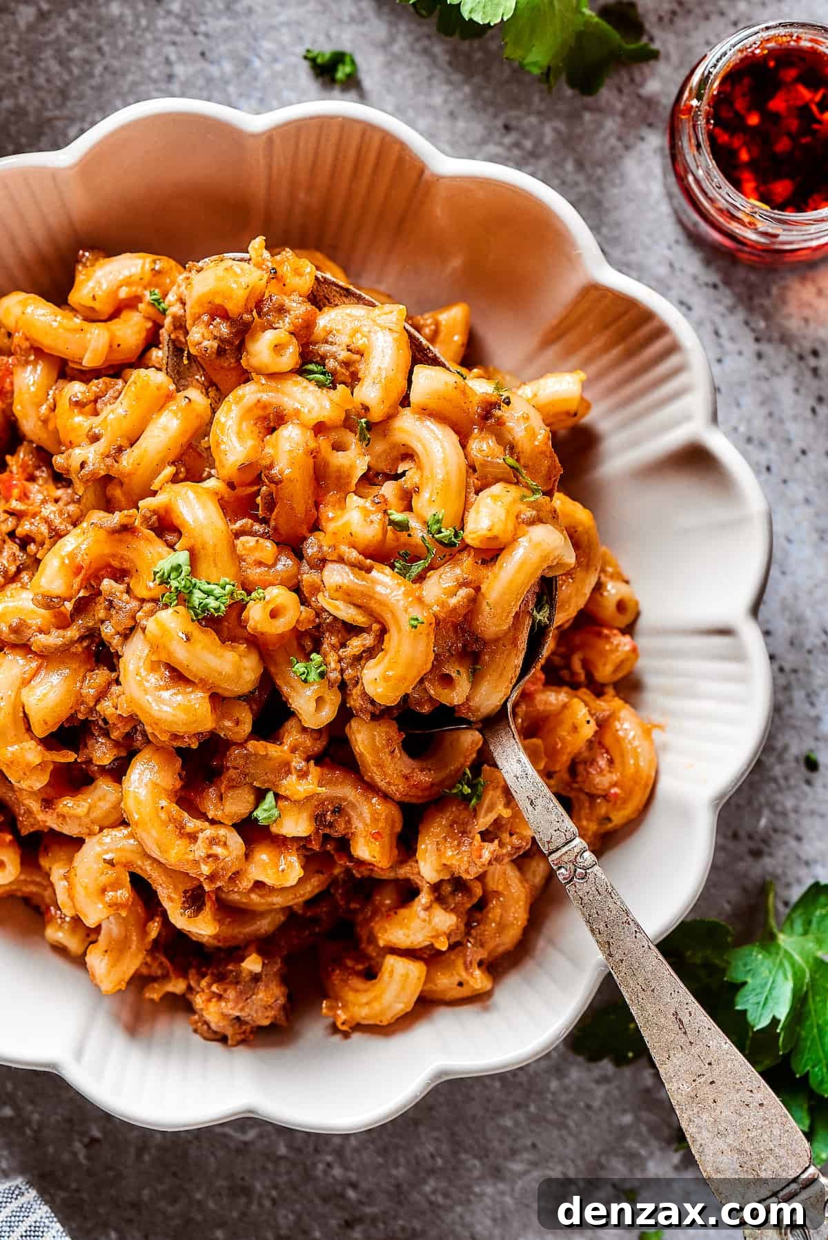 A bowl of pasta casserole with beef.
