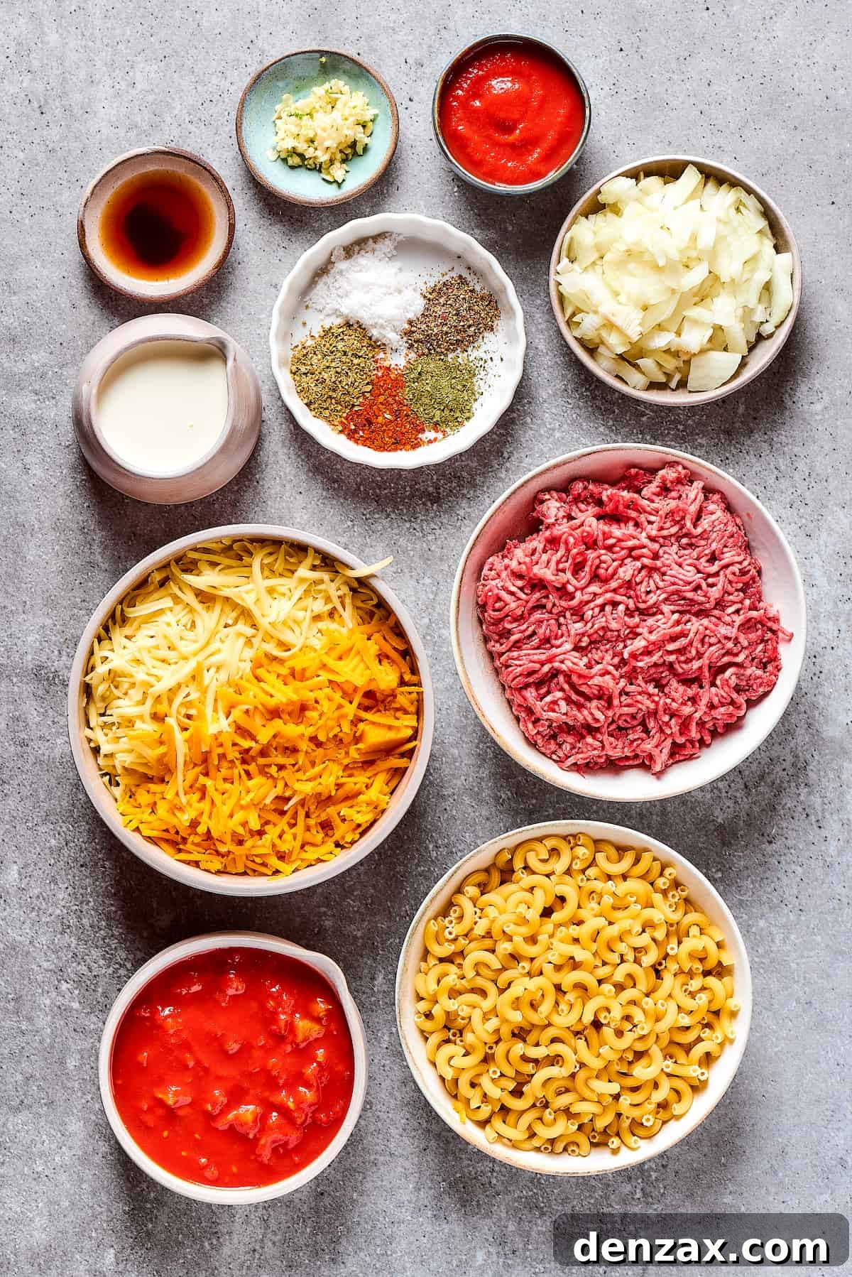 Ingredients for cheeseburger casserole, measured and arranged on a work surface.