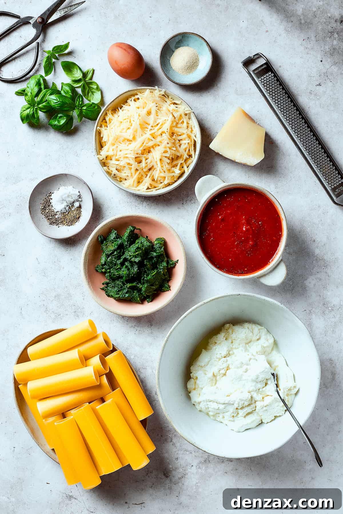 Stuffed manicotti ingredients arranged on a work surface.