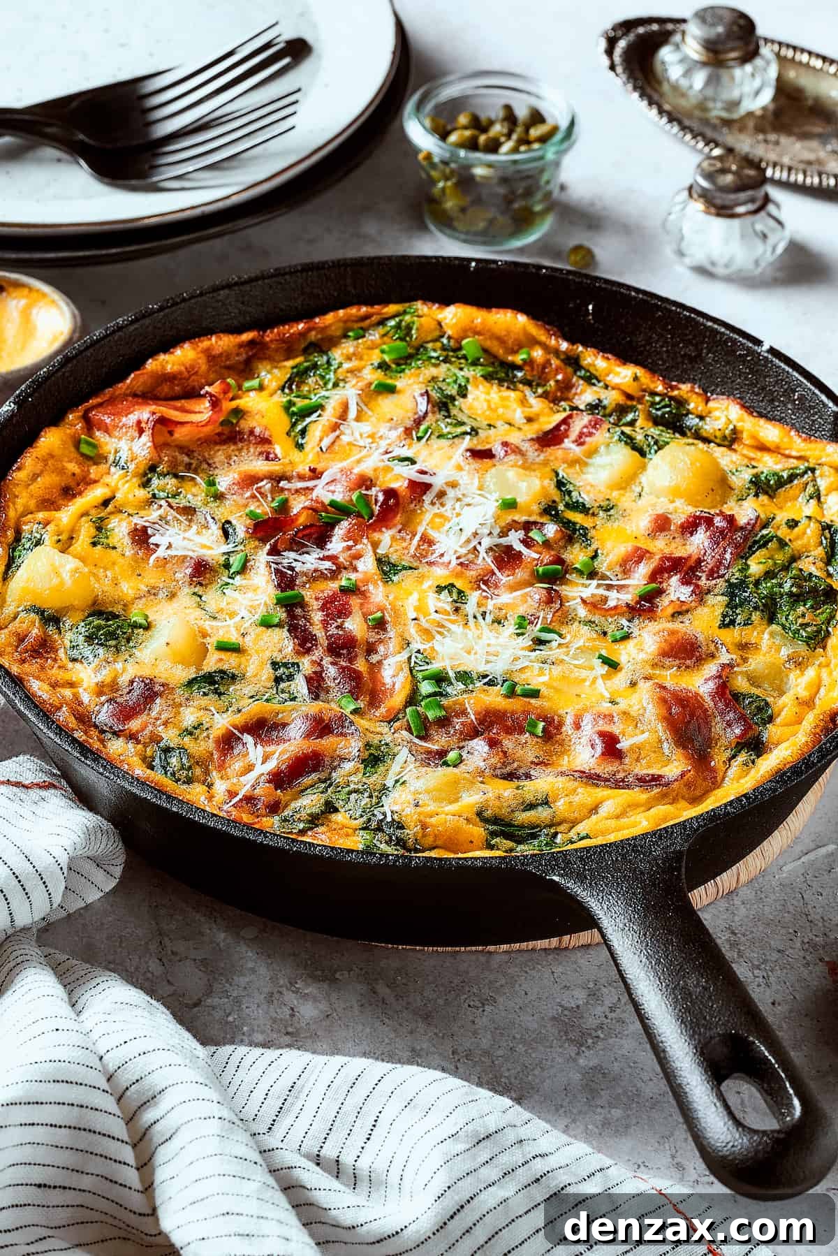 A cast-iron skillet with a baked egg dish in it.