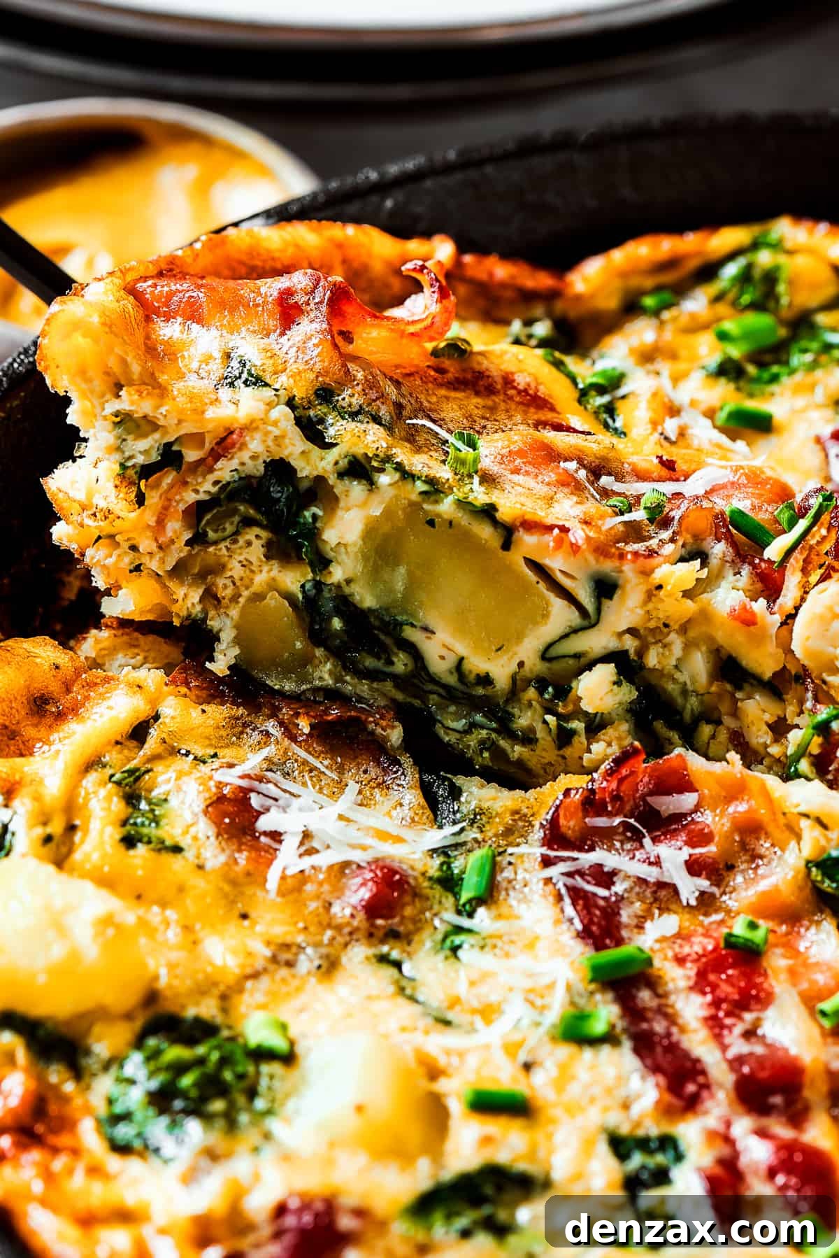 Lifting a slice of frittata out of a pan.
