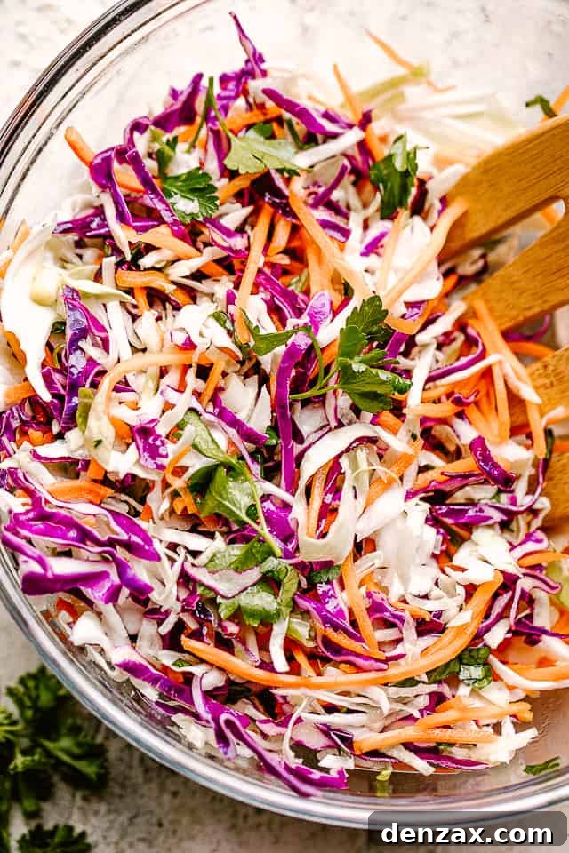 Stirring through shredded red and green cabbage and carrots.