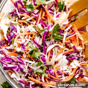 Stirring through shredded red and green cabbage and carrots.