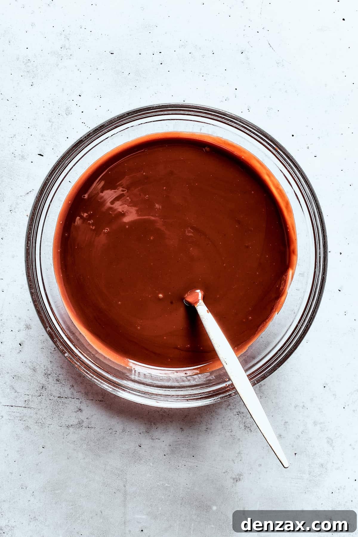A bowl of melted chocolate sauce.