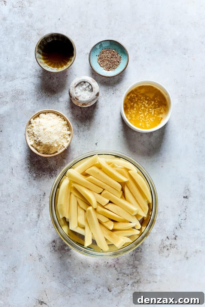 Cut fries soaking in water, with other ingredients in dishes on the work surface.
