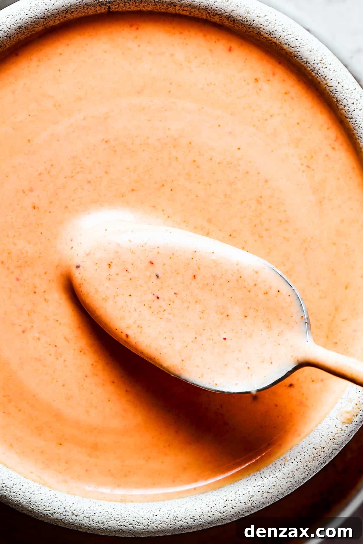 Yum Yum Sauce is a scrumptious, creamy condiment that adds a burst of flavor to any dish. You'll love this sweet, tangy Japanese sauce! A close-up photo of Homemade yum yum sauce in a bowl.