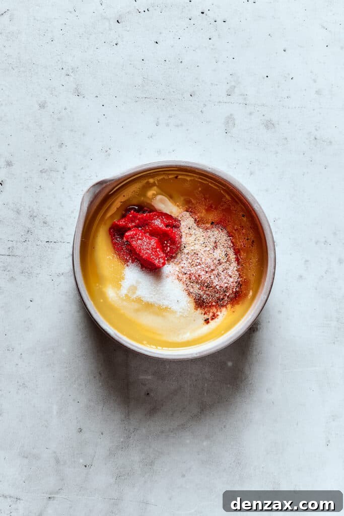Yum Yum Sauce is a scrumptious, creamy condiment that adds a burst of flavor to any dish. You'll love this sweet, tangy Japanese sauce! Sauce ingredients in a bowl.
