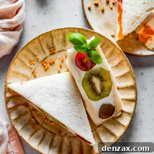 Overhead shot of fruit sandwich halves on a plate.