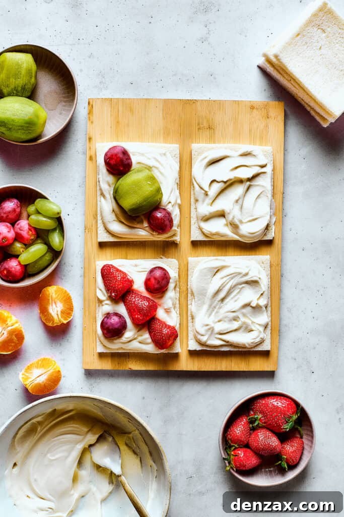 Arranging fruit on bread with whipped cream.