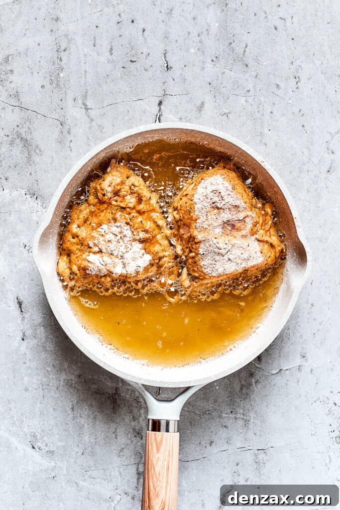 Frying the chicken in a skillet.