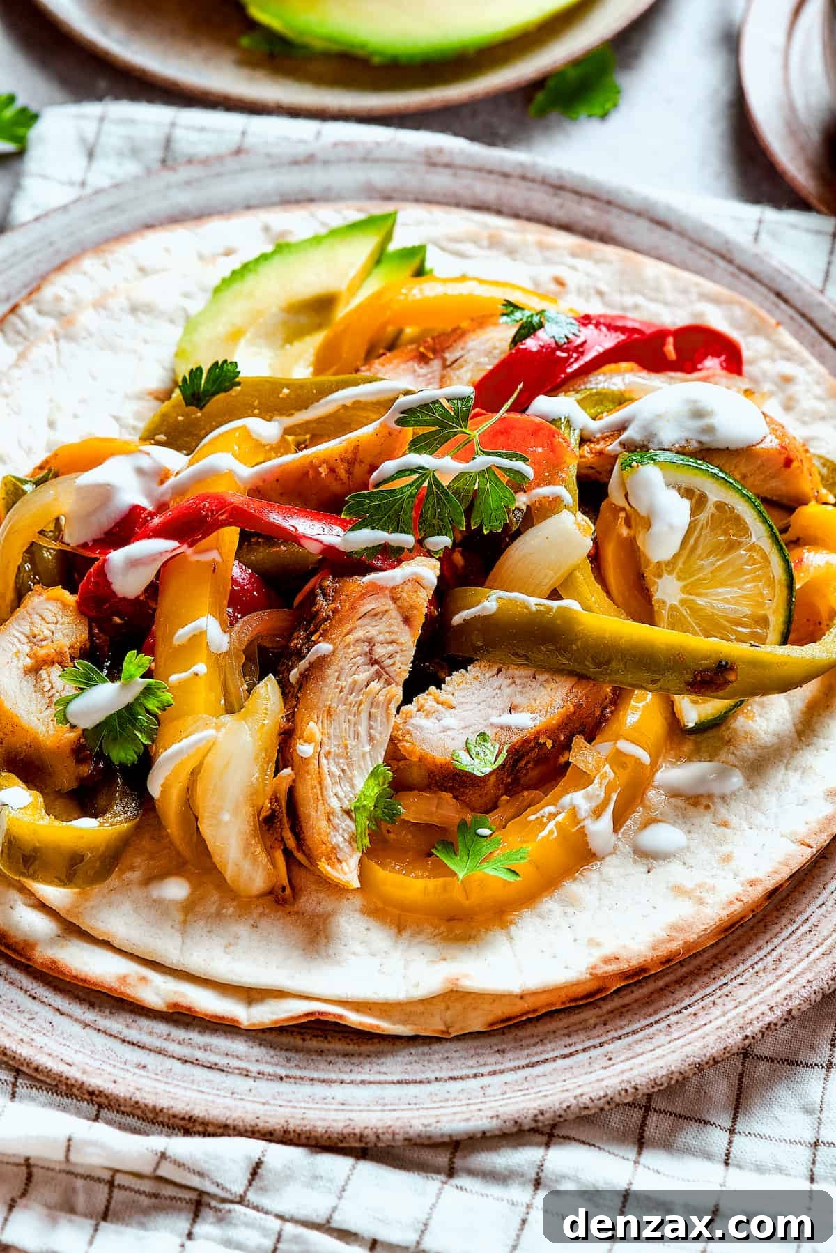 Homemade chicken fajitas with vegetables and lime slices.