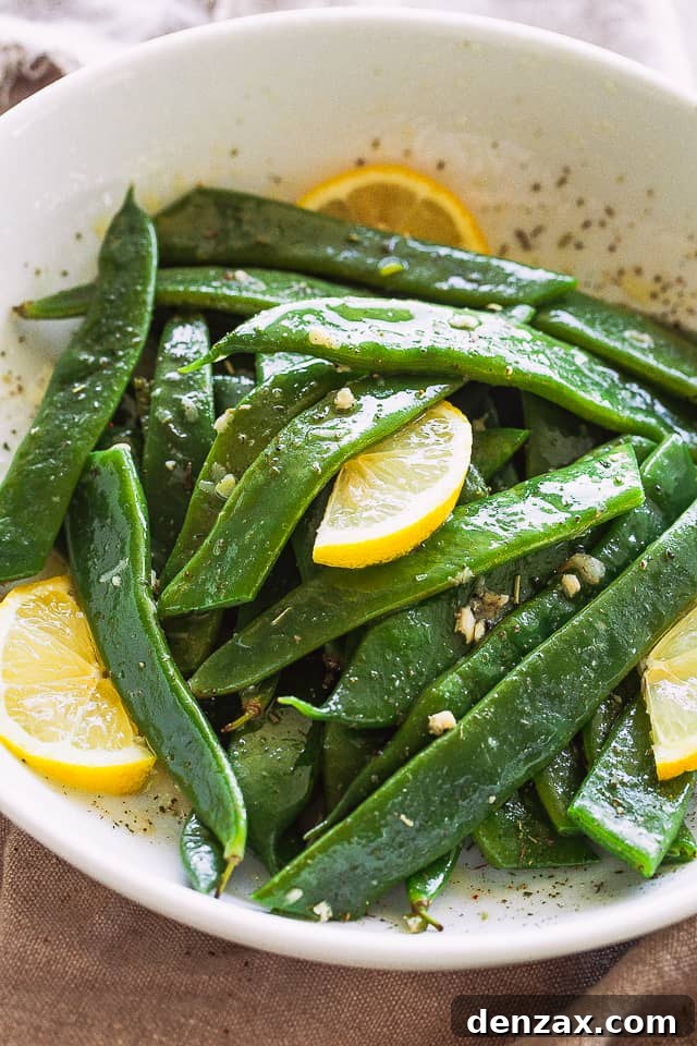 Garlic Butter Romano Beans served with lemon slices.