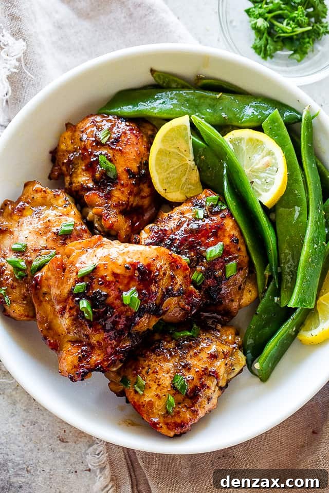 Romano flat beans served on a plate with browned chicken thighs.