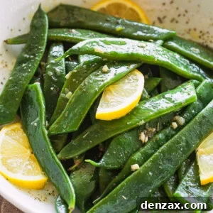 Garlic Butter Romano Beans served with lemon slices.