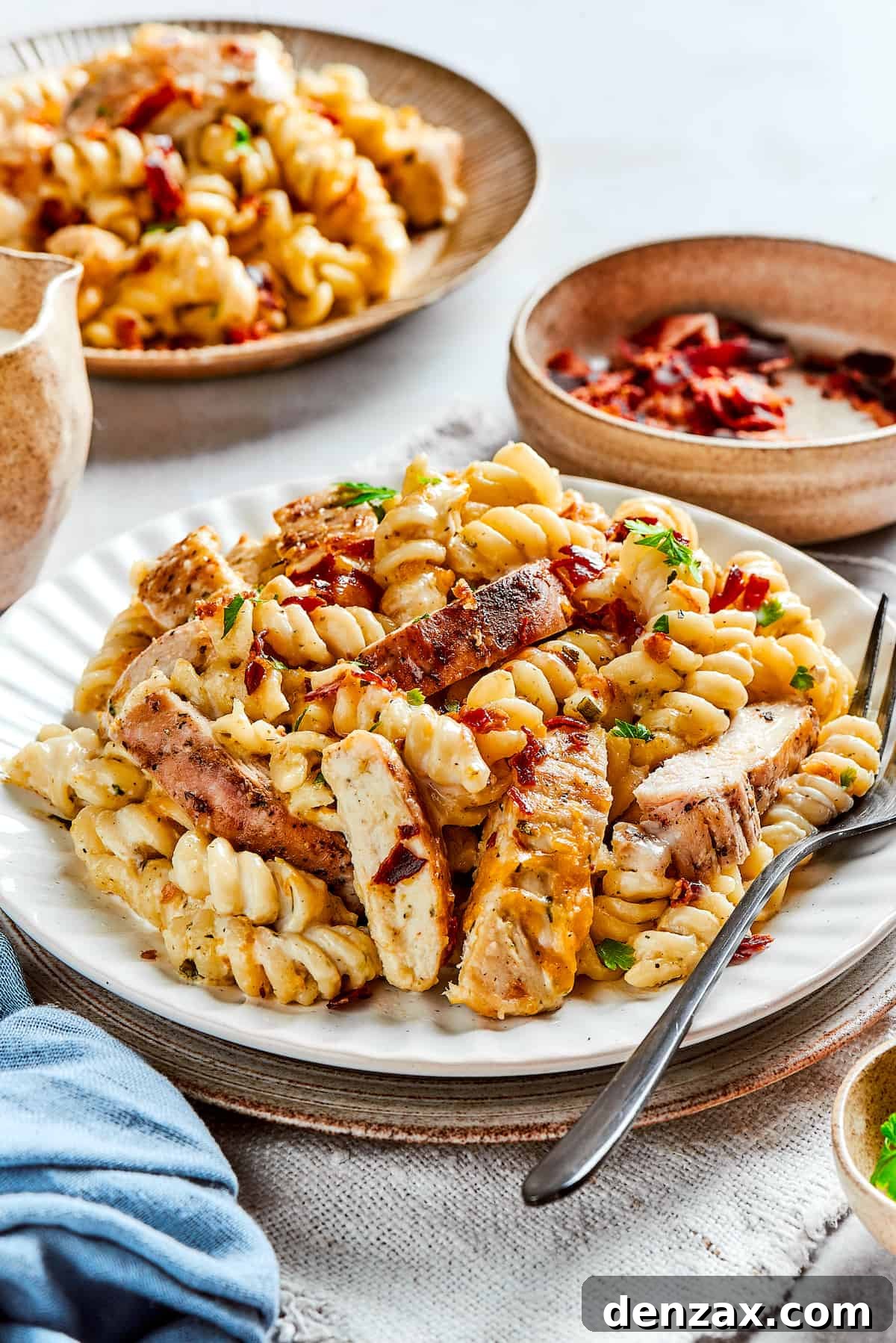 This bold and creamy Chicken Bacon Ranch Pasta recipe is a savory, smoky dinner dish that's bursting with flavor! The best comfort food! Plates of pasta with chicken.