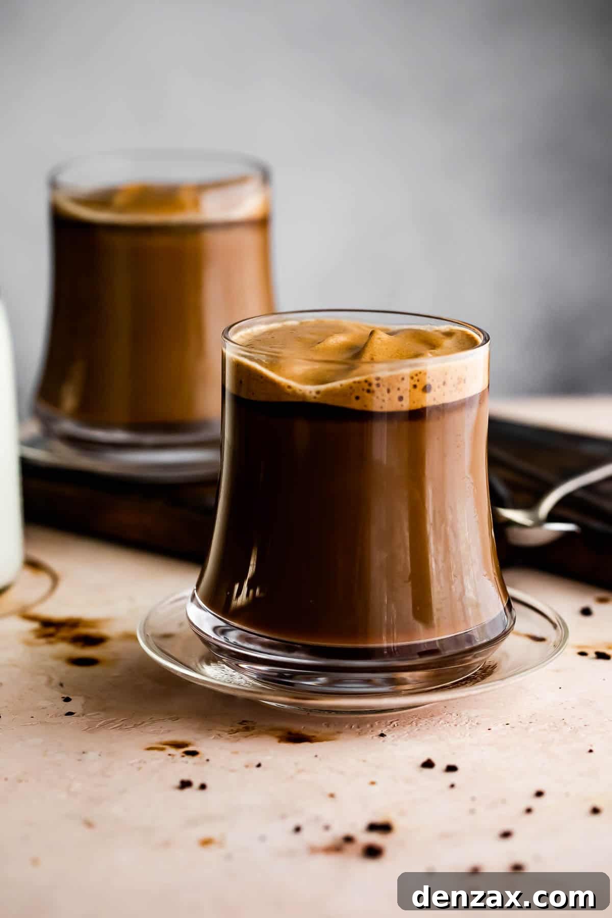 Image of two glass coffee mugs filled with coffee.