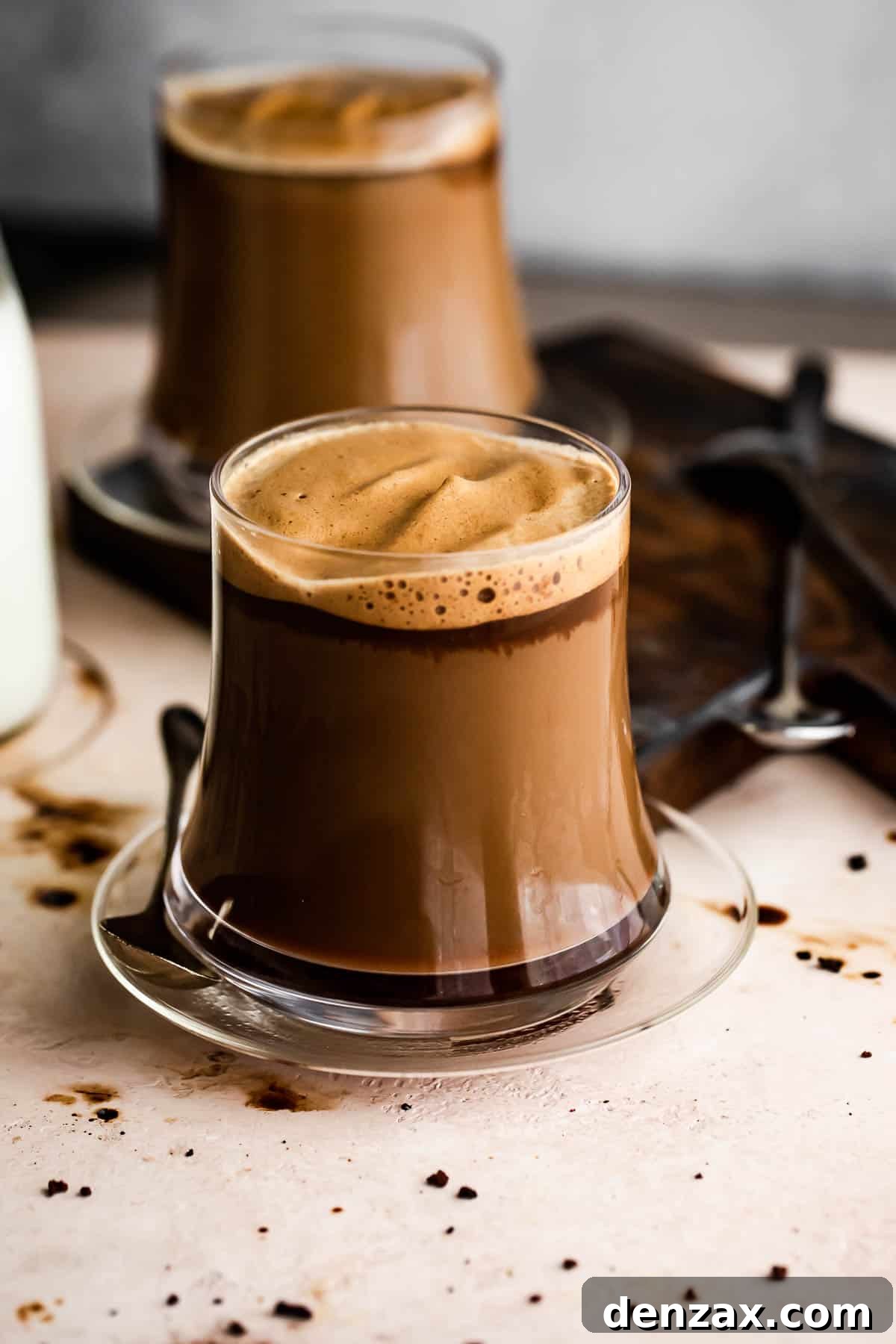 Image of two glass coffee mugs filled with coffee.