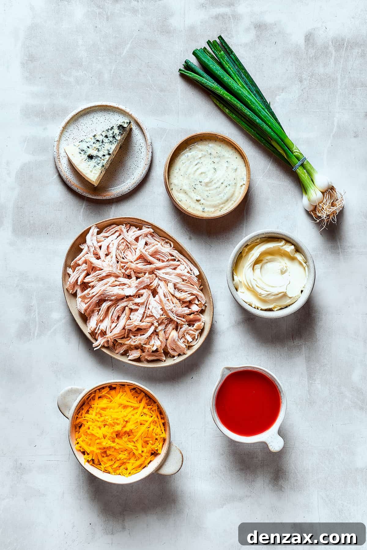 With its creamy, cheesy, spicy goodness, Crockpot Buffalo Chicken Dip is a favorite for parties, game days, movie night, and more! Ingredients for crockpot buffalo chicken dip, arranged on a table.