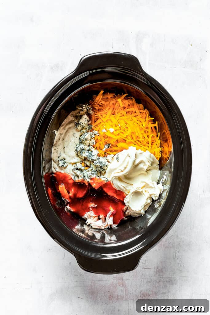 With its creamy, cheesy, spicy goodness, Crockpot Buffalo Chicken Dip is a favorite for parties, game days, movie night, and more! Cream cheese, blue cheese, chicken, and other ingredients in a slow cooker insert.