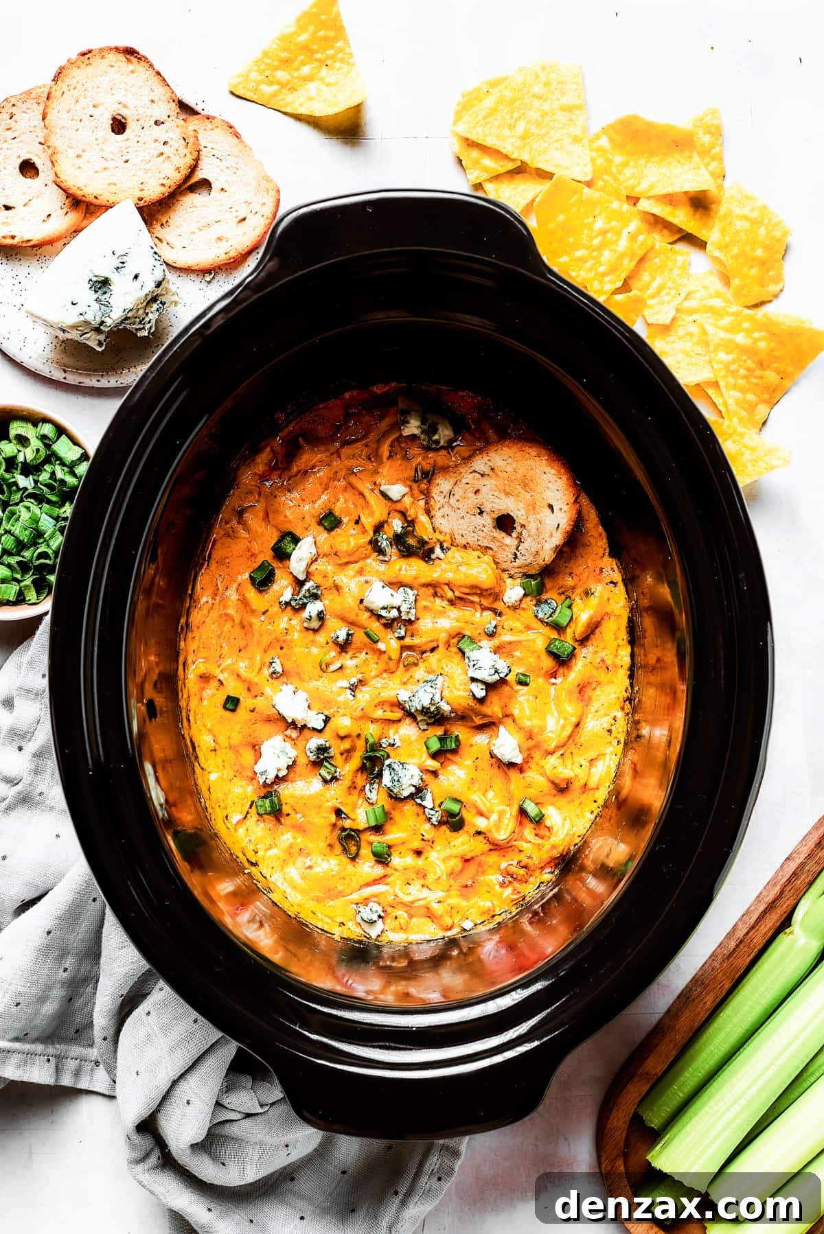 With its creamy, cheesy, spicy goodness, Crockpot Buffalo Chicken Dip is a favorite for parties, game days, movie night, and more! A slow cooker insert full of cheesy dip.