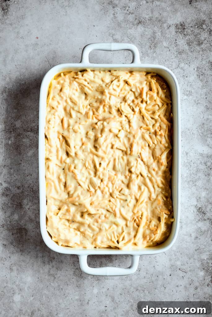 Potato mixture spread into a casserole dish.