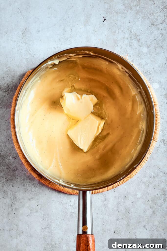 Stirring butter into warm pudding.