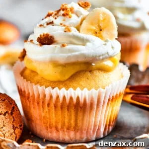 One banana pudding cupcake on a dessert plate. More cupcakes are in the background of the shot.