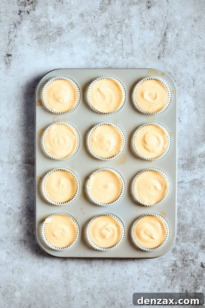 Unbaked cupcakes in a cupcake pan.