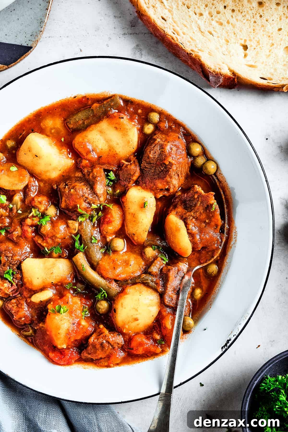 Overhead shot of a bowl with mulligan stew with mixed vegetables.