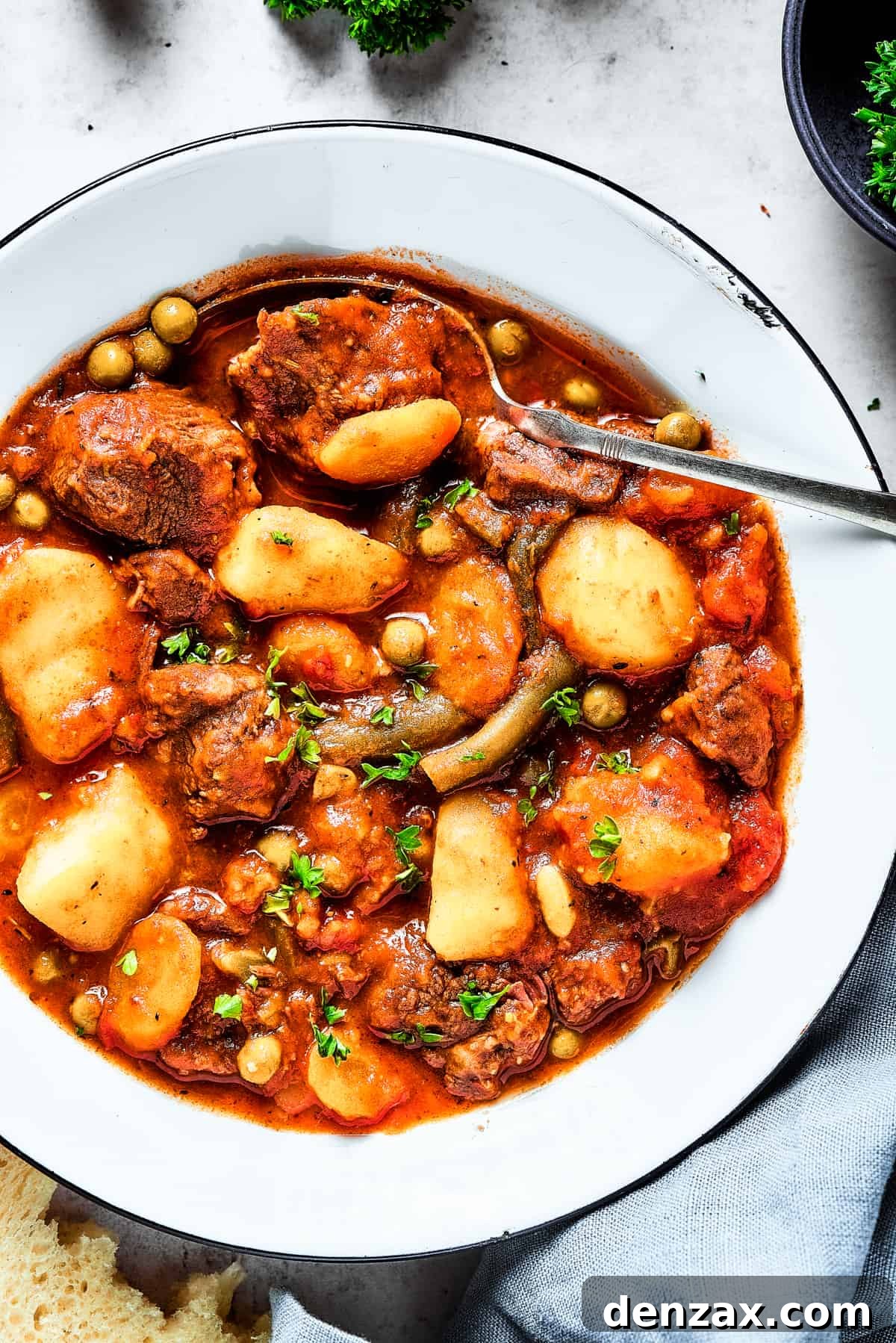 Overhead close-up shot of mulligan stew with mixed vegetables.