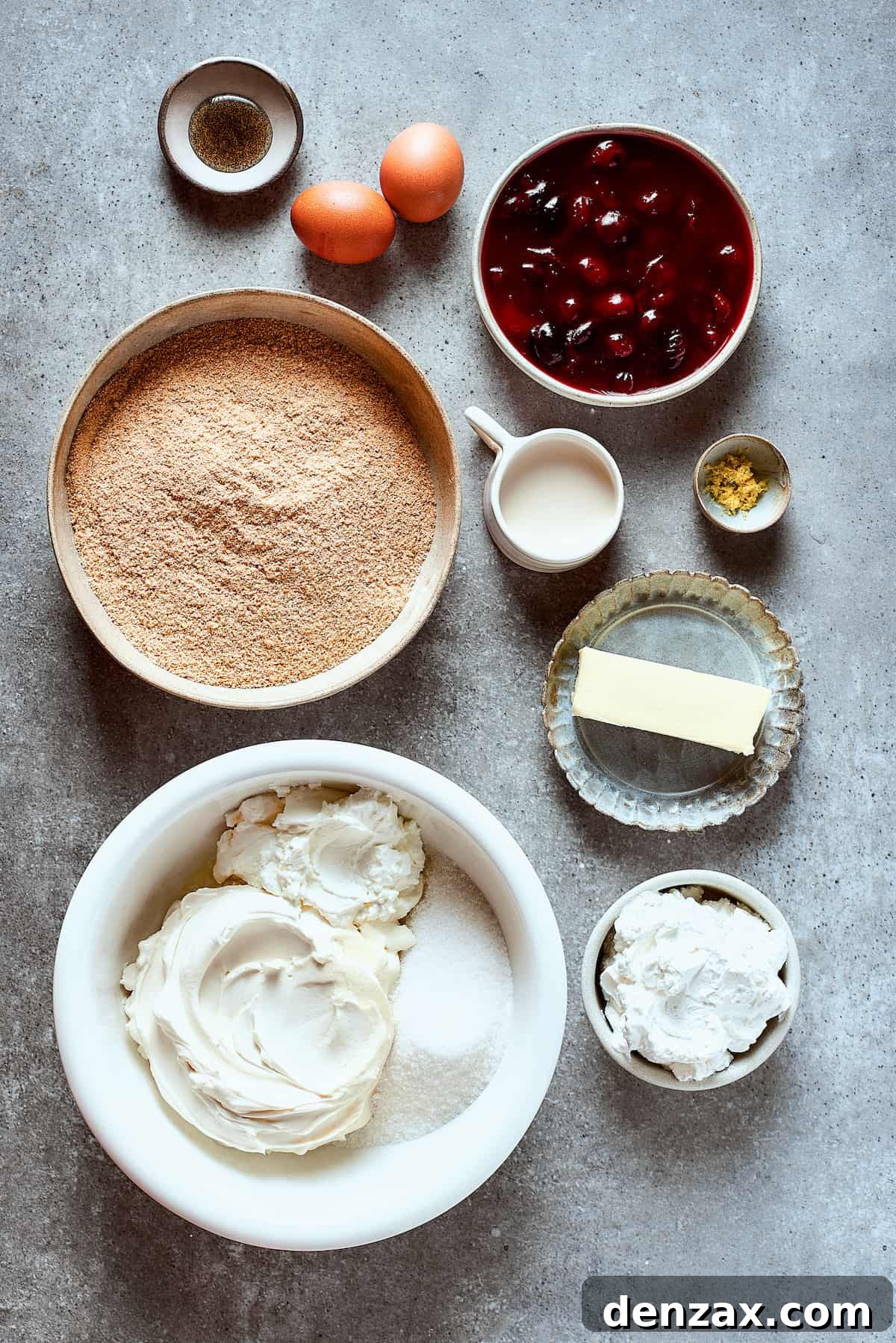 Ingredients for cherry cheesecake arranged on a work surface.