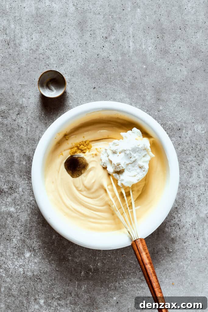 Beating additional ingredients into a mixing bowl.